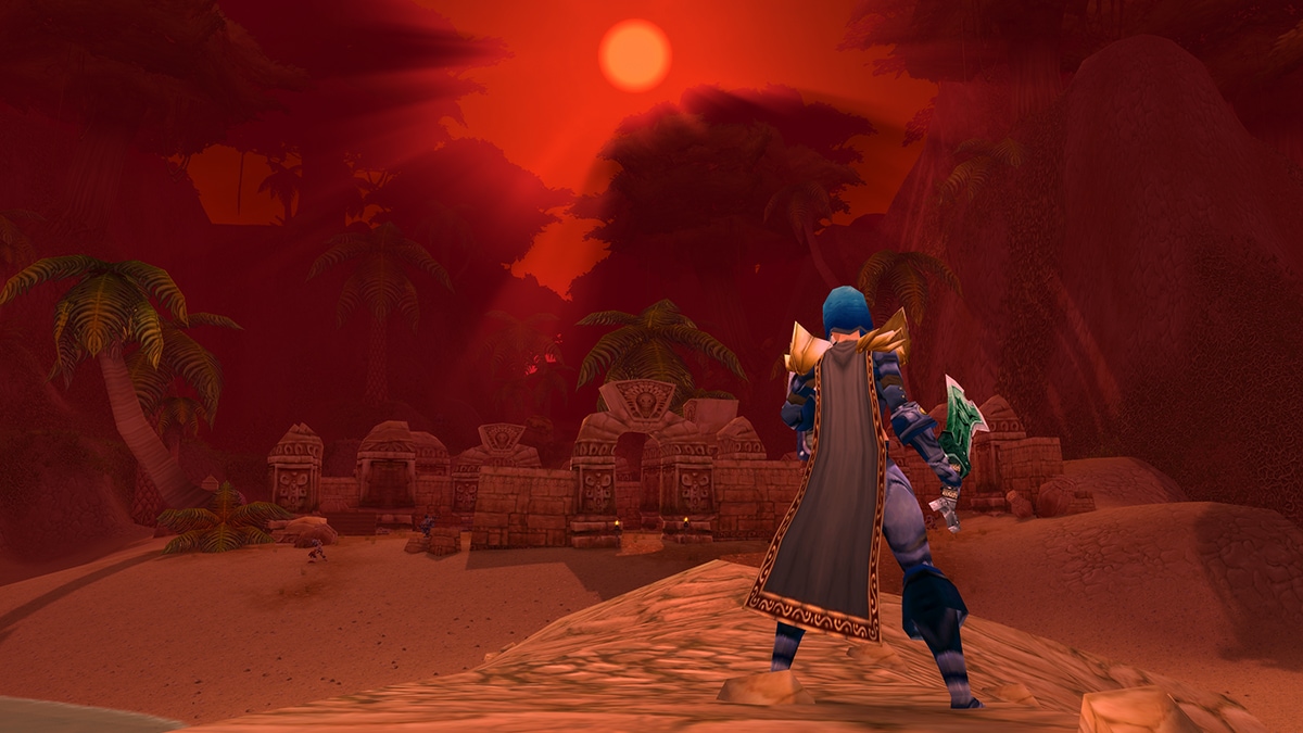 A Human standing near ruins in Stranglethorn Vale with an orange sky