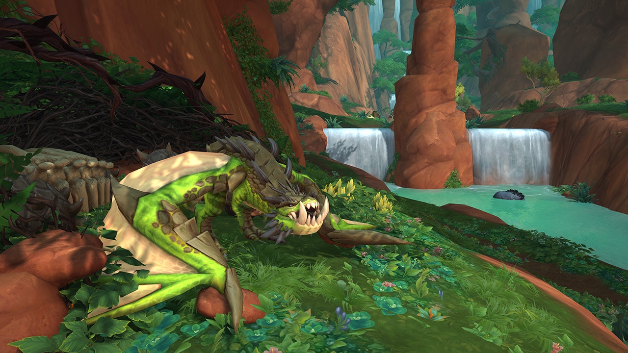 A green protodrake sits next to a river in the forest with a waterfall