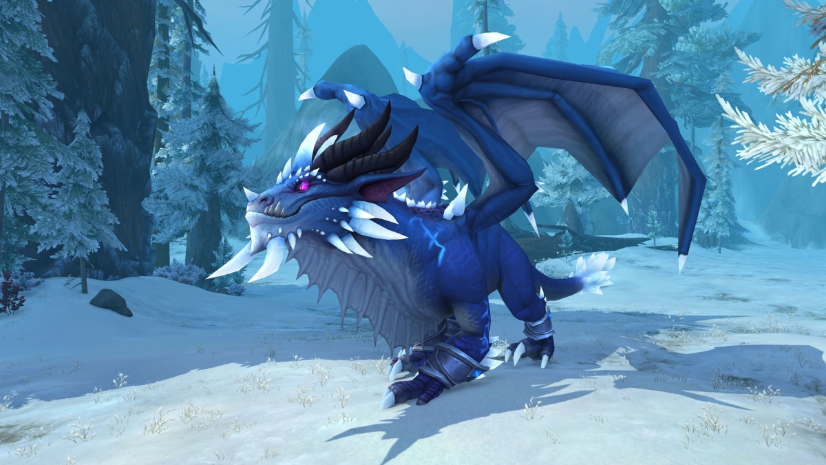 A picture of a large blue dragon with snow and trees