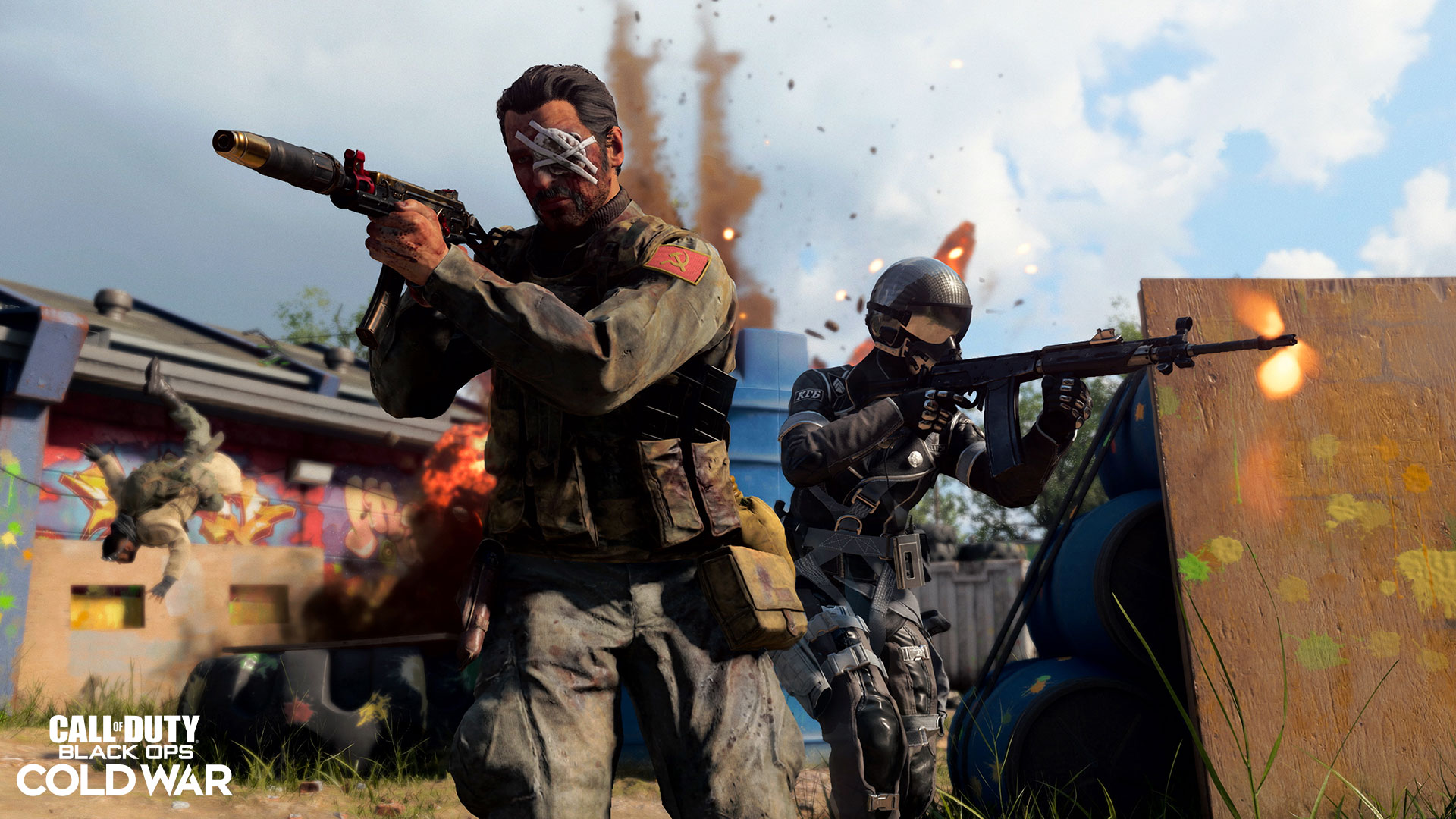 Two people with guns on a paintball range